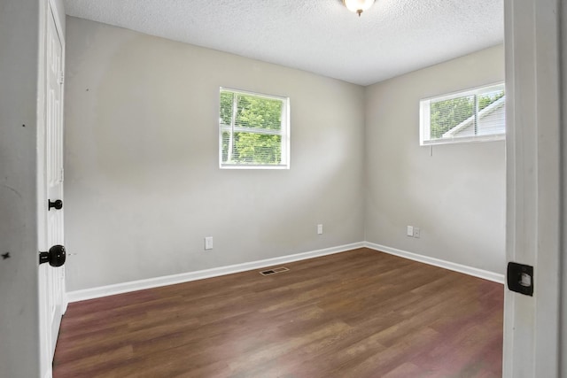 5011 Jarrett Rd, Chattanooga, TN 37416 - spare room featuring plenty of natural light, dark wood finished floors, and a textured ceiling