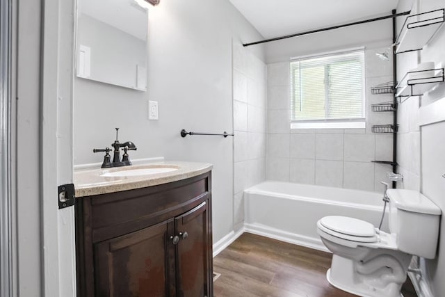 5011 Jarrett Rd, Chattanooga, TN 37416 - full bathroom featuring vanity, wood finished floors, and washtub / shower combination