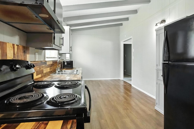 5011 Jarrett Rd, Chattanooga, TN 37416 - kitchen featuring black appliances, ventilation hood, and light wood-style flooring