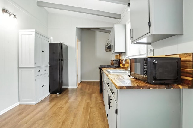 5011 Jarrett Rd, Chattanooga, TN 37416 - kitchen with black appliances, butcher block countertops, light wood-style flooring, and white cabinetry