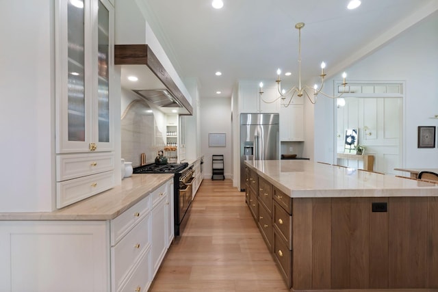 1744 Blackburn Ln, Spring Hill, TN 37174 - kitchen with premium appliances, white cabinetry, a large island, light wood finished floors, and glass insert cabinets