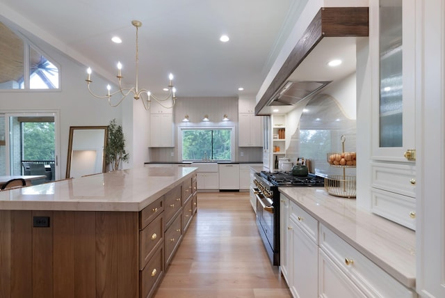 1744 Blackburn Ln, Spring Hill, TN 37174 - kitchen with high end range, white cabinetry, white dishwasher, a kitchen island, and light stone counters