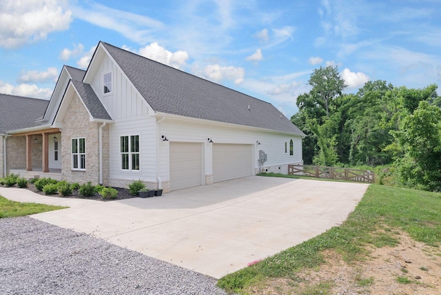 1744 Blackburn Ln, Spring Hill, TN 37174 - view of property exterior featuring board and batten siding, concrete driveway, an attached garage, stone siding, and a shingled roof