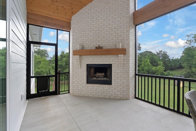 1744 Blackburn Ln, Spring Hill, TN 37174 - unfurnished sunroom with a fireplace, vaulted ceiling, and healthy amount of natural light