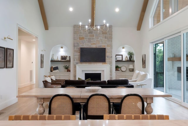 1744 Blackburn Ln, Spring Hill, TN 37174 - dining space featuring beamed ceiling, a chandelier, wood finished floors, a fireplace, and built in shelves