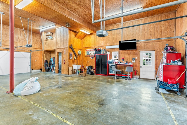 541 Lakeview Cir, Mount Juliet, TN 37122 - garage featuring a garage door opener, wood walls, and a workshop area