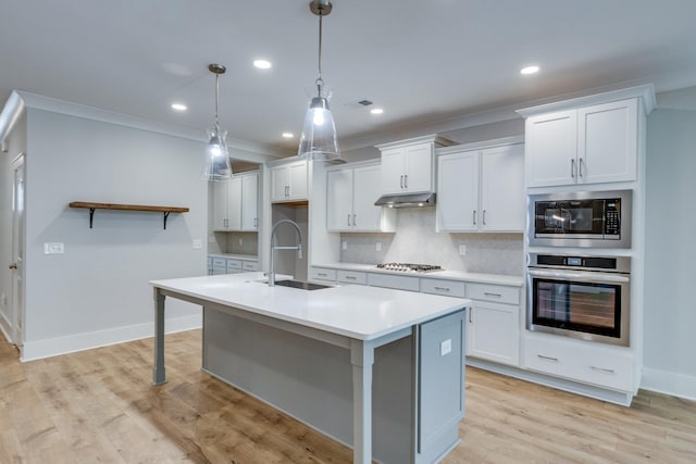 2110 Lequire Ln, Spring Hill, TN 37174 - kitchen with stainless steel appliances, decorative backsplash, light countertops, white cabinets, and an island with sink
