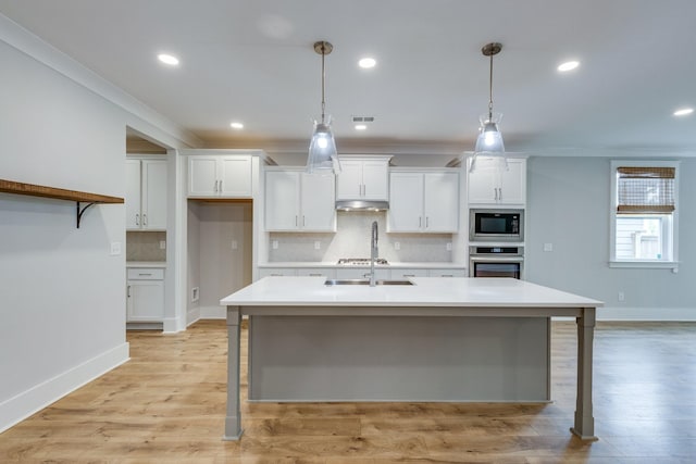2110 Lequire Ln, Spring Hill, TN 37174 - kitchen with appliances with stainless steel finishes, under cabinet range hood, white cabinetry, light countertops, and backsplash