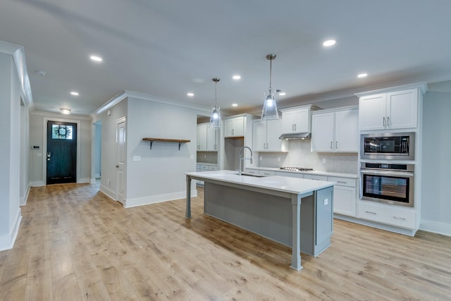 2110 Lequire Ln, Spring Hill, TN 37174 - kitchen with stainless steel appliances, ornamental molding, light countertops, white cabinets, and recessed lighting