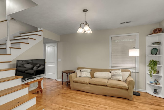 3316 Burr Rd, Springfield, TN 37172 - living room with stairs, light wood-style flooring, and a chandelier