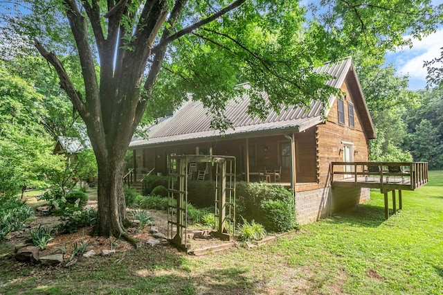 3316 Burr Rd, Springfield, TN 37172 - view of side of home featuring a metal roof, a yard, a wooden deck, and log exterior