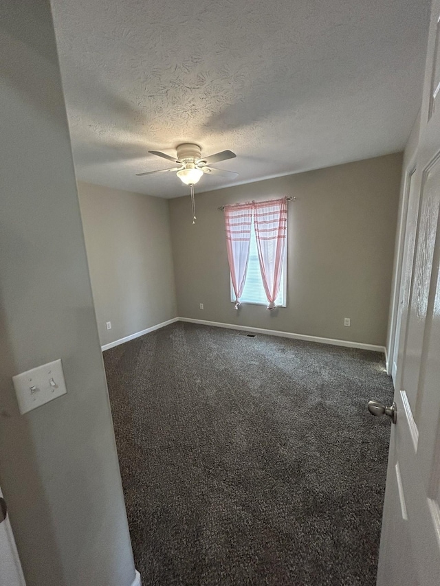 1911 Days Rd, Lafayette, TN 37083 - unfurnished room featuring dark colored carpet, a ceiling fan, and a textured ceiling