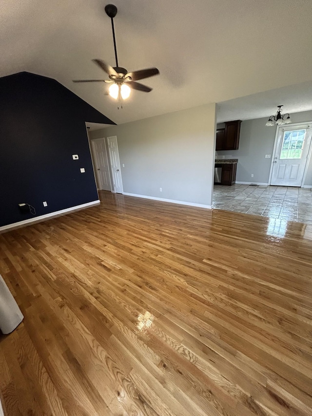 1911 Days Rd, Lafayette, TN 37083 - unfurnished living room with vaulted ceiling, light wood-style flooring, and ceiling fan