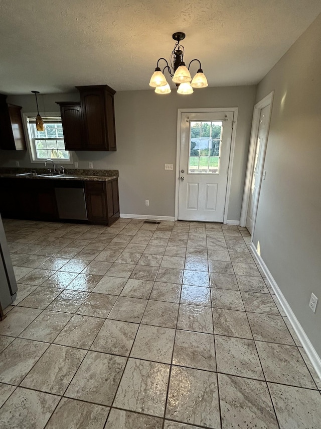 1911 Days Rd, Lafayette, TN 37083 - kitchen with stainless steel dishwasher, plenty of natural light, a textured ceiling, dark brown cabinetry, and a chandelier