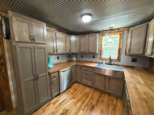 175 State Route 22a S, Jacks Creek, TN 38347 - kitchen featuring wooden counters, stainless steel dishwasher, light wood-style flooring, and decorative light fixtures