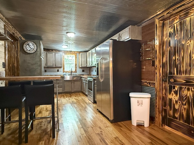 175 State Route 22a S, Jacks Creek, TN 38347 - kitchen featuring appliances with stainless steel finishes, light wood-type flooring, gray cabinetry, and light countertops