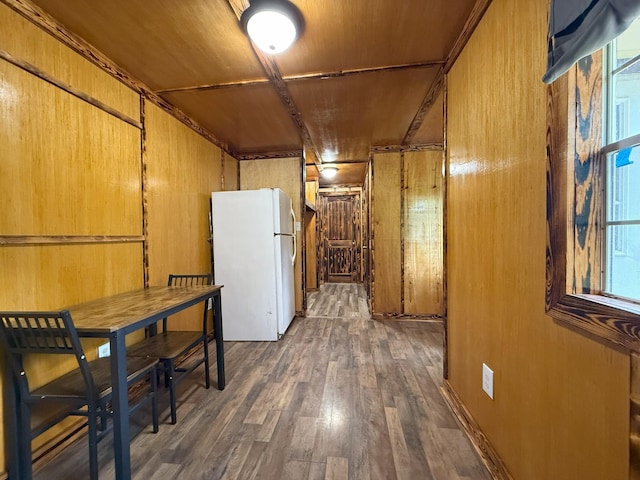 175 State Route 22a S, Jacks Creek, TN 38347 - kitchen featuring freestanding refrigerator, wood finished floors, wood walls, healthy amount of natural light, and brown cabinetry