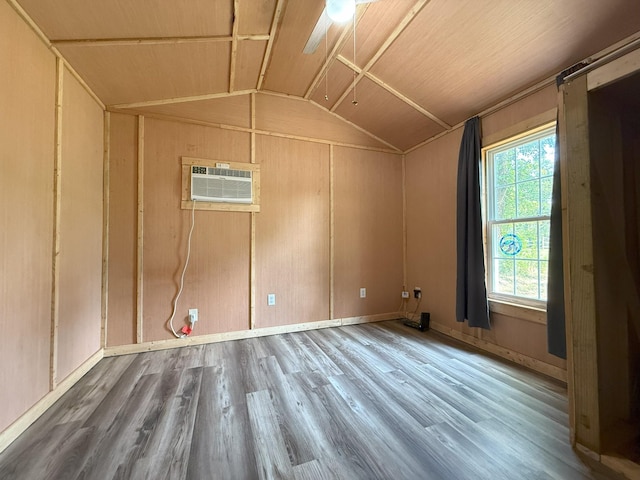 175 State Route 22a S, Jacks Creek, TN 38347 - unfurnished room with vaulted ceiling, a wall unit AC, and wood finished floors