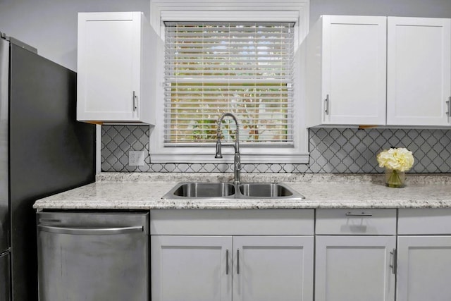 119 N Forrest Ave, Camden, TN 38320 - kitchen featuring stainless steel dishwasher, white cabinetry, decorative backsplash, and light stone countertops