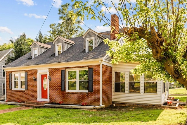 119 N Forrest Ave, Camden, TN 38320 - cape cod-style house with brick siding, a chimney, a front lawn, and roof with shingles