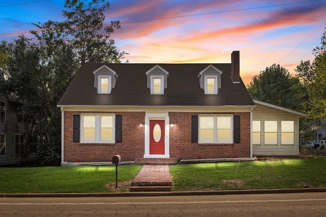119 N Forrest Ave, Camden, TN 38320 - new england style home with brick siding, a chimney, and a lawn