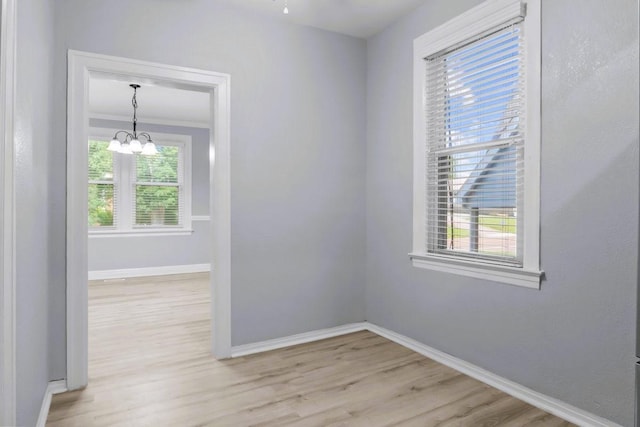 119 N Forrest Ave, Camden, TN 38320 - empty room with wood finished floors and a chandelier