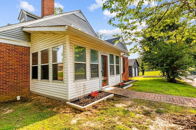 119 N Forrest Ave, Camden, TN 38320 - view of side of property with a lawn, brick siding, and a chimney