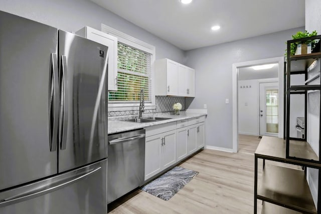 119 N Forrest Ave, Camden, TN 38320 - kitchen featuring appliances with stainless steel finishes, white cabinets, light wood-style floors, backsplash, and recessed lighting