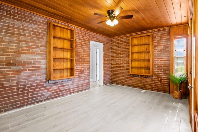 119 N Forrest Ave, Camden, TN 38320 - unfurnished room with wooden ceiling, built in shelves, ceiling fan, brick wall, and light wood-type flooring