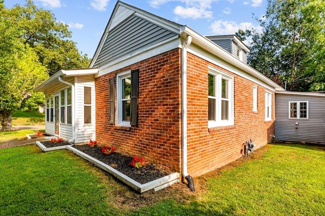 119 N Forrest Ave, Camden, TN 38320 - view of home's exterior with brick siding and a yard
