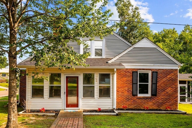 119 N Forrest Ave, Camden, TN 38320 - bungalow-style home featuring a front yard, brick siding, and roof with shingles