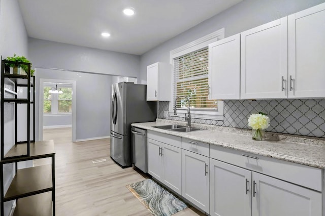 119 N Forrest Ave, Camden, TN 38320 - kitchen with dishwasher, light wood finished floors, decorative backsplash, recessed lighting, and white cabinetry