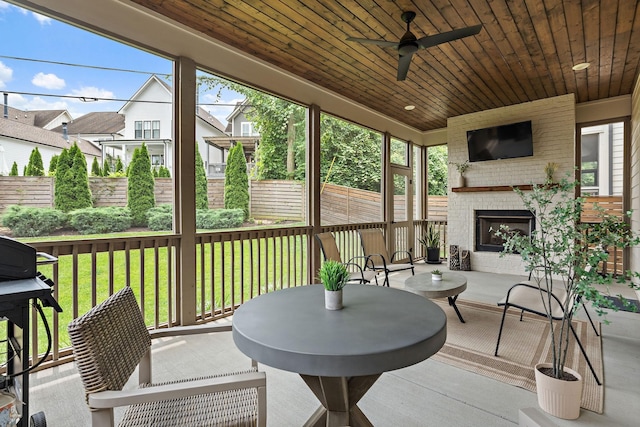 1931 Warfield Dr, Nashville, TN 37215 - sunroom / solarium featuring an outdoor brick fireplace, ceiling fan, and plenty of natural light