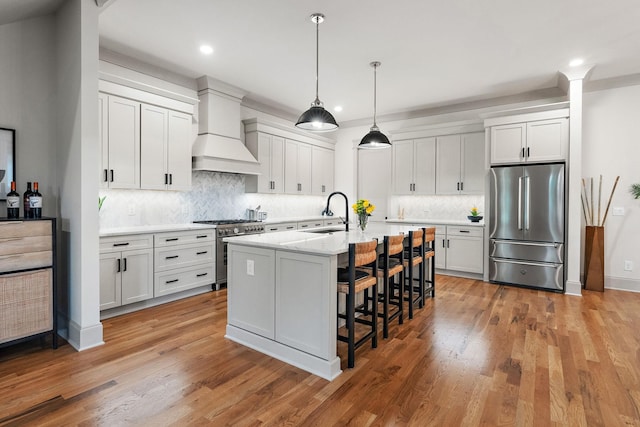 1931 Warfield Dr, Nashville, TN 37215 - kitchen featuring high end appliances, premium range hood, a kitchen bar, recessed lighting, and tasteful backsplash