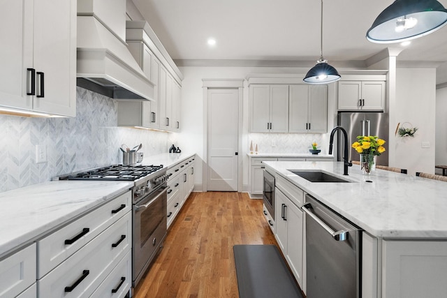 1931 Warfield Dr, Nashville, TN 37215 - kitchen with high end appliances, custom exhaust hood, a center island with sink, white cabinetry, and recessed lighting