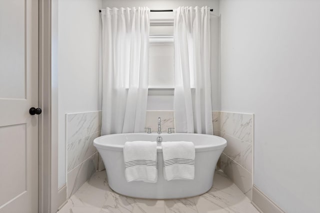 1931 Warfield Dr, Nashville, TN 37215 - full bathroom featuring marble look tiles, tile walls, wainscoting, and a freestanding tub