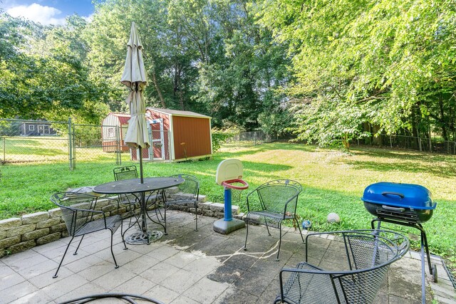 106 Hogin Rd, Dickson, TN 37055 - fenced backyard with a storage unit, a patio area, and outdoor dining space