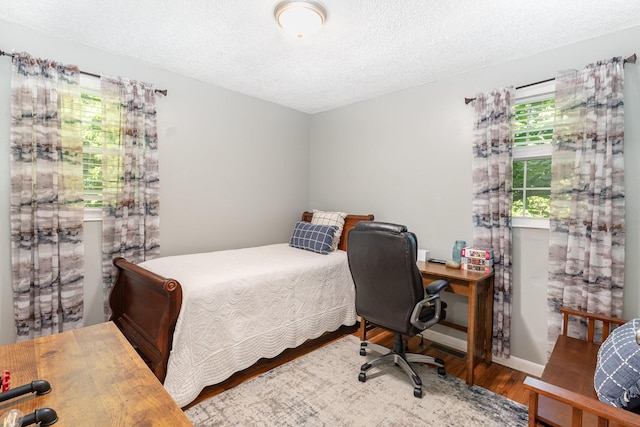 106 Hogin Rd, Dickson, TN 37055 - bedroom featuring wood finished floors, a textured ceiling, and a desk