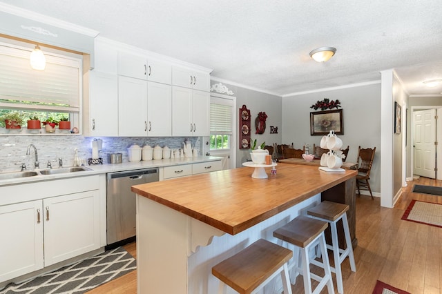 106 Hogin Rd, Dickson, TN 37055 - kitchen featuring stainless steel dishwasher, butcher block counters, light wood finished floors, healthy amount of natural light, and crown molding