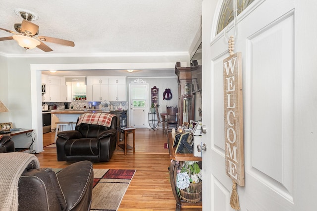 106 Hogin Rd, Dickson, TN 37055 - living area featuring light wood finished floors, ceiling fan, ornamental molding, and a textured ceiling