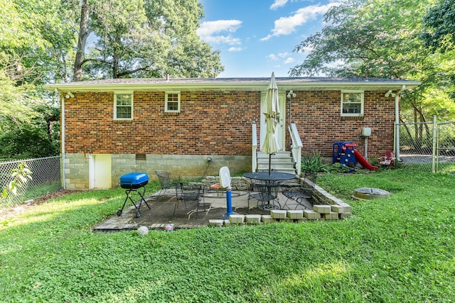 106 Hogin Rd, Dickson, TN 37055 - back of house featuring brick siding, a fenced backyard, entry steps, and a patio area