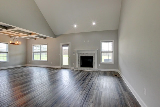 1331 Juniper Pass, Clarksville, TN 37043 - unfurnished living room with a chandelier, dark wood-style floors, healthy amount of natural light, a fireplace, and high vaulted ceiling