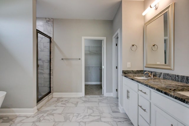 1331 Juniper Pass, Clarksville, TN 37043 - full bathroom with marble look tiles, a shower stall, double vanity, and a walk in closet