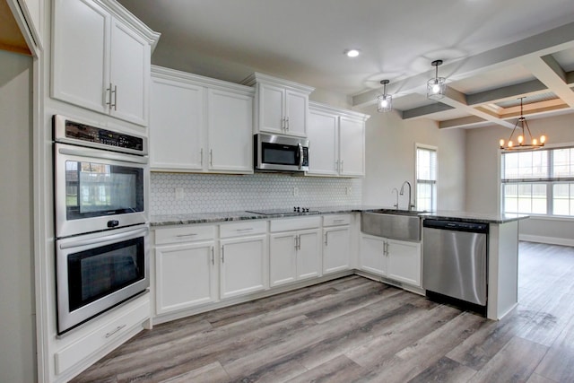 1331 Juniper Pass, Clarksville, TN 37043 - kitchen featuring appliances with stainless steel finishes, a peninsula, recessed lighting, backsplash, and white cabinets
