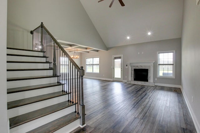 1331 Juniper Pass, Clarksville, TN 37043 - unfurnished living room with dark wood-type flooring, stairway, high vaulted ceiling, ceiling fan, and a fireplace