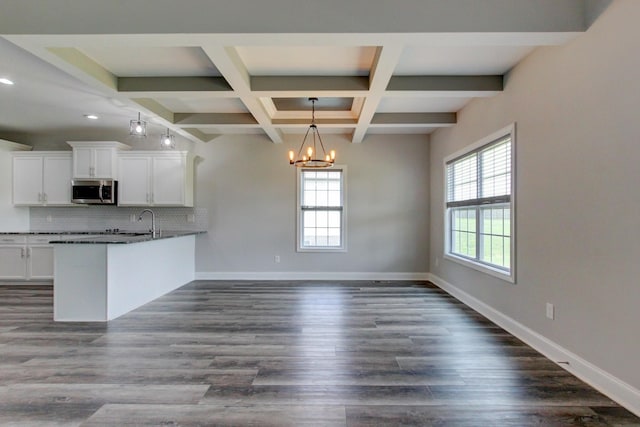1331 Juniper Pass, Clarksville, TN 37043 - kitchen featuring stainless steel microwave, a chandelier, white cabinetry, a peninsula, and tasteful backsplash
