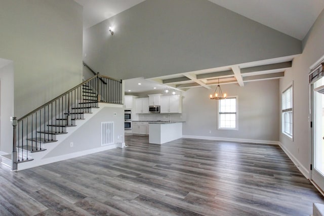 1331 Juniper Pass, Clarksville, TN 37043 - unfurnished living room featuring a high ceiling, a chandelier, stairs, dark wood finished floors, and beamed ceiling