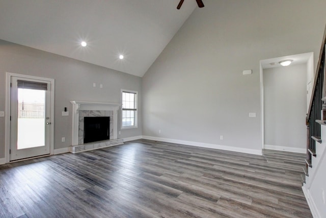 1331 Juniper Pass, Clarksville, TN 37043 - unfurnished living room with high vaulted ceiling, stairway, a ceiling fan, wood finished floors, and a high end fireplace