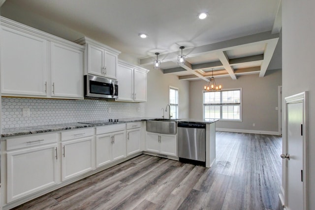 1331 Juniper Pass, Clarksville, TN 37043 - kitchen with appliances with stainless steel finishes, recessed lighting, a peninsula, backsplash, and white cabinets