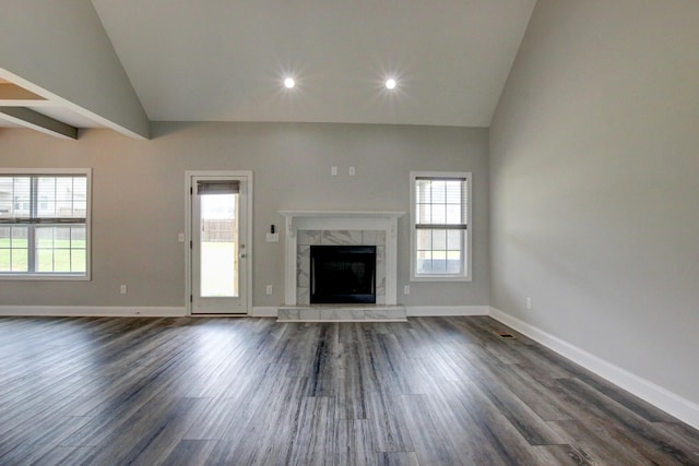 1331 Juniper Pass, Clarksville, TN 37043 - unfurnished living room featuring vaulted ceiling, a fireplace, plenty of natural light, dark wood finished floors, and recessed lighting